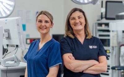 Dr Heidi McAlpine and Prof Kate Drummond AM in scrubs