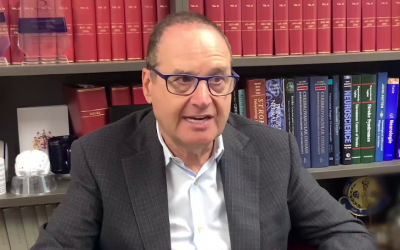 Professor Stephen Davis sitting in front of office bookshelf